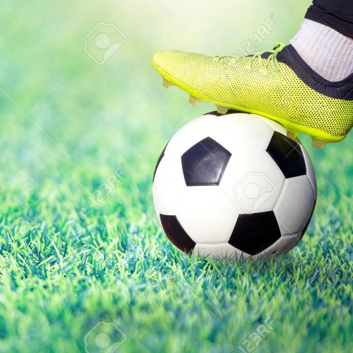 110890416-foot-of-a-soccer-player-in-a-football-boot-on-a-ball-on-an-green-lawn-of-the-stadium